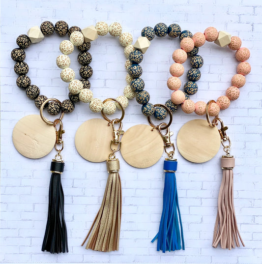 LEOPARD WOODEN BEADS WRISTLET - FAUX LEATHER TASSEL